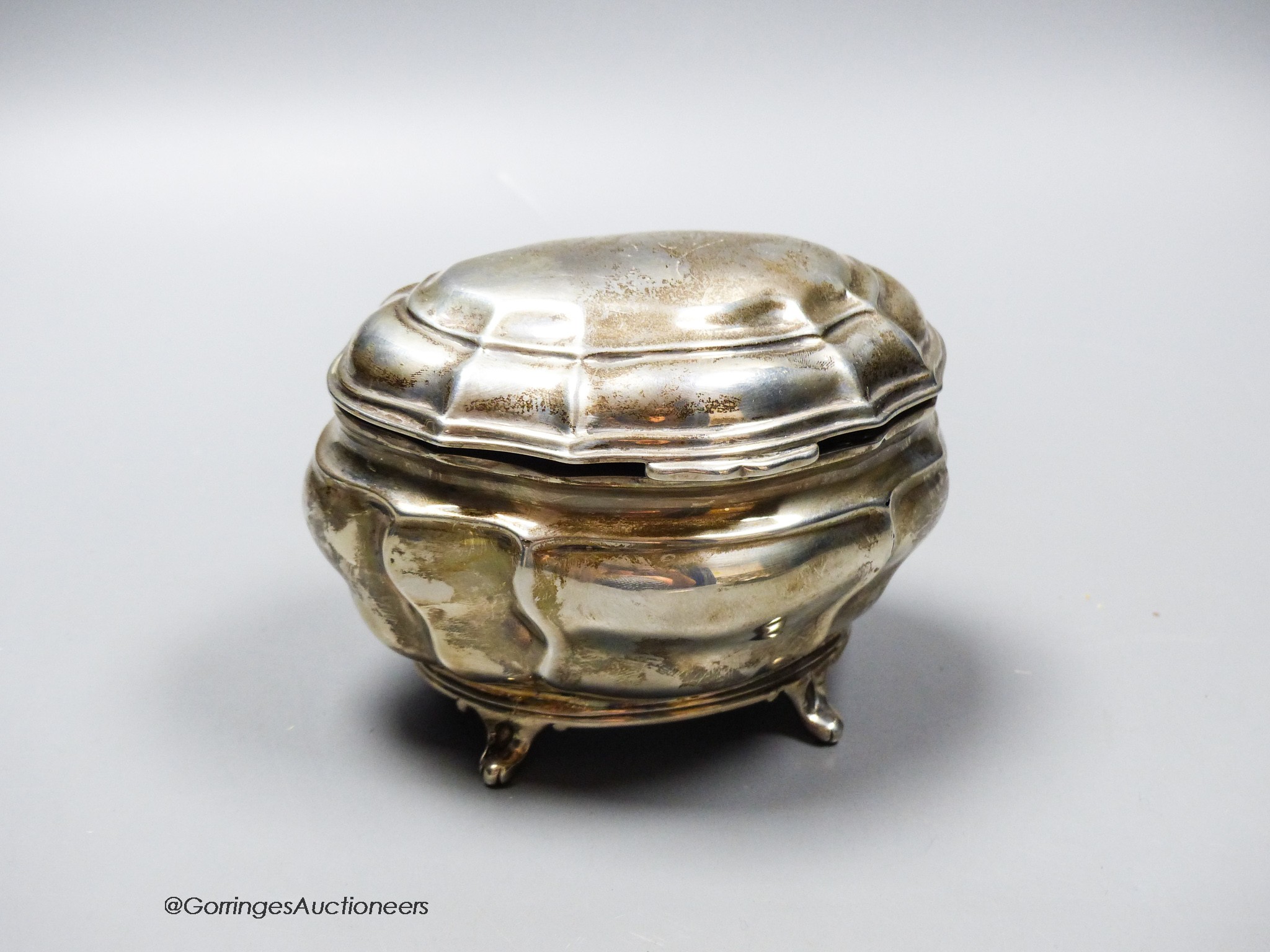 An Edwardian silver shaped oval tea caddy, Charles Stuart Harris Ltd, London, 1902, length 13.4cm, 7.5oz.